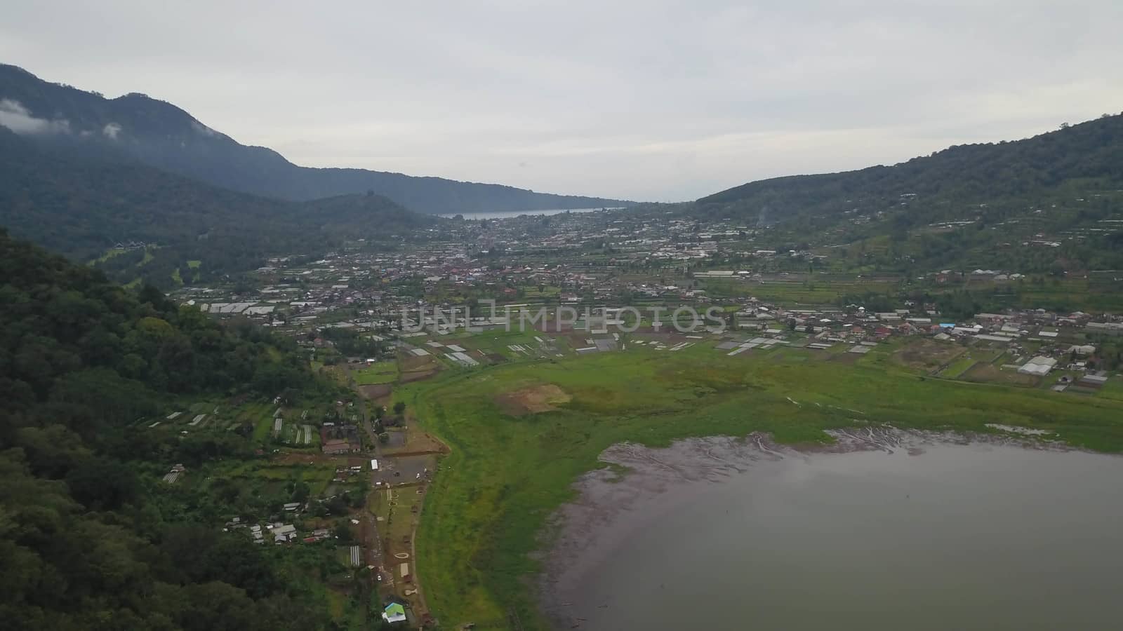 Beatiful aerial drone view over the lake. Lake and mountain view from a hill, Buyan Lake, Bali.