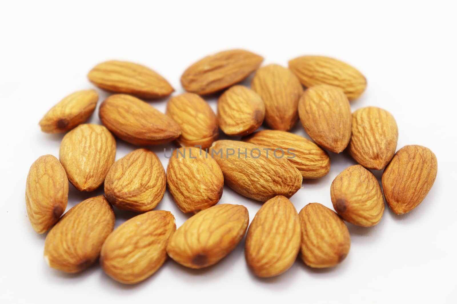 tasty and healthy brown colored almond stock on white background