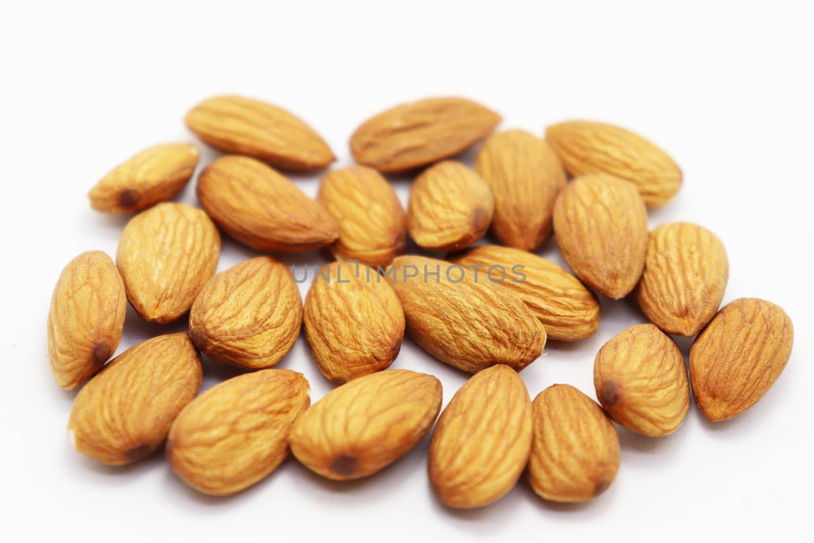 tasty and healthy brown colored almond stock on white background