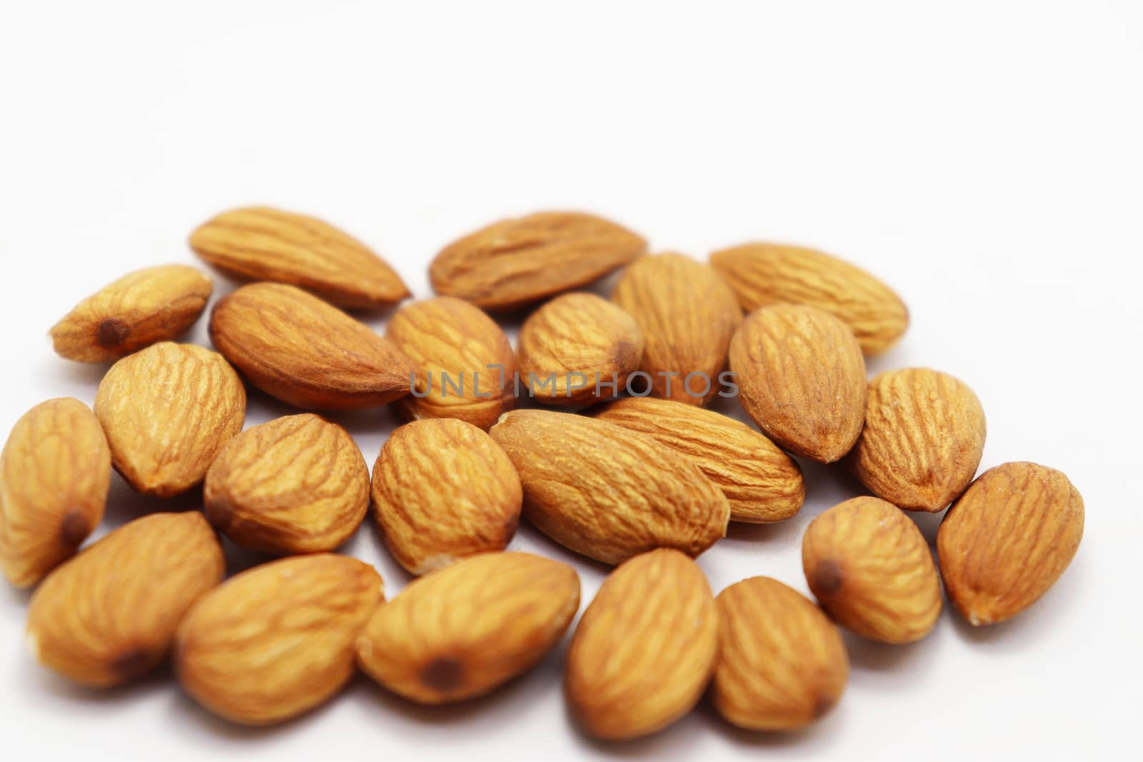 tasty and healthy brown colored almond stock on white background