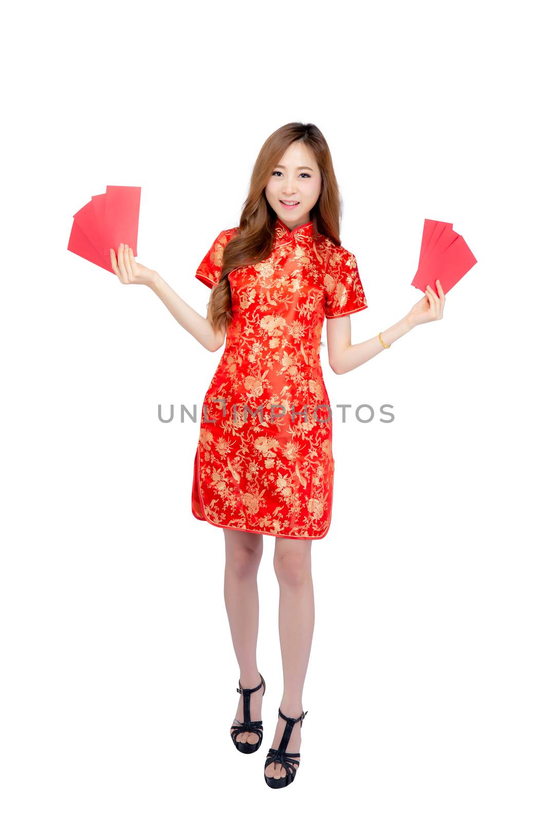 Beautiful portrait young asian woman cheongsam dress smiling holding red envelope on white background, beauty asia girl wear qipao celebrate with exciting, happy Chinese New Year, holiday concept.