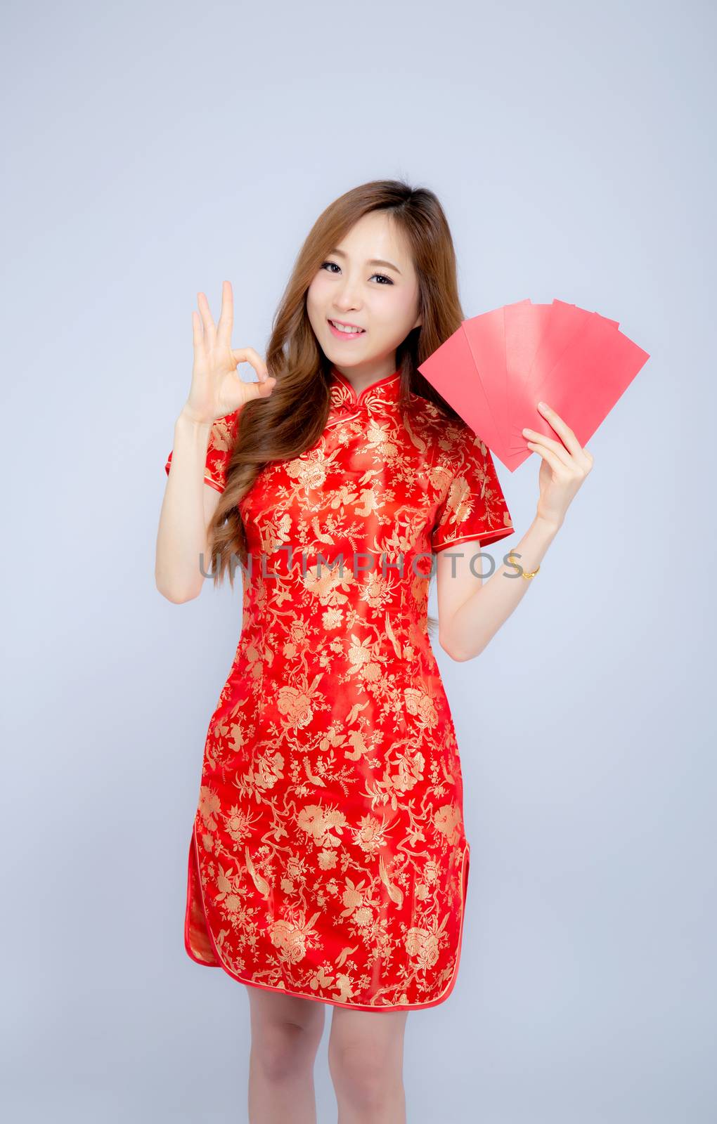 Beautiful portrait young asian woman cheongsam dress smiling hol by nnudoo