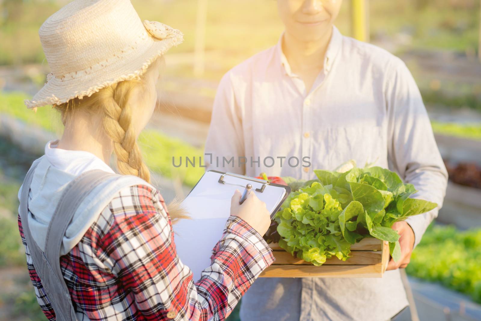 Young asian woman checking vegetable organic hydroponic farm and by nnudoo