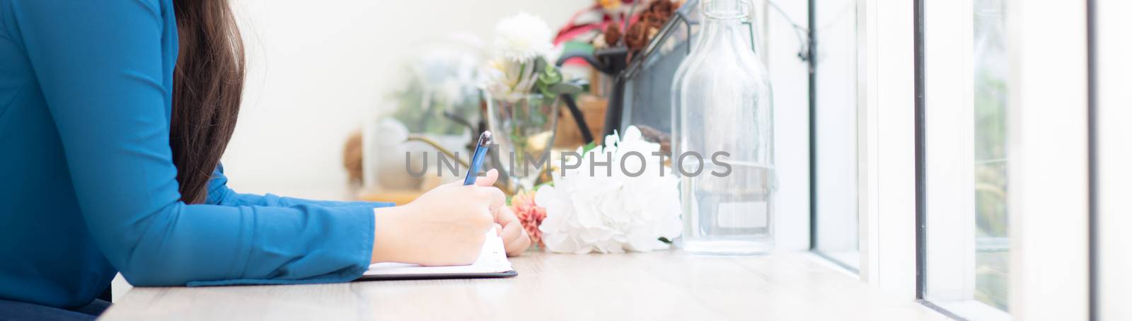 Beautiful portrait young asia woman writer writing on notebook or diary with happy, lifestyle of asian girl is student, female planning working, education and business concept, banner website.