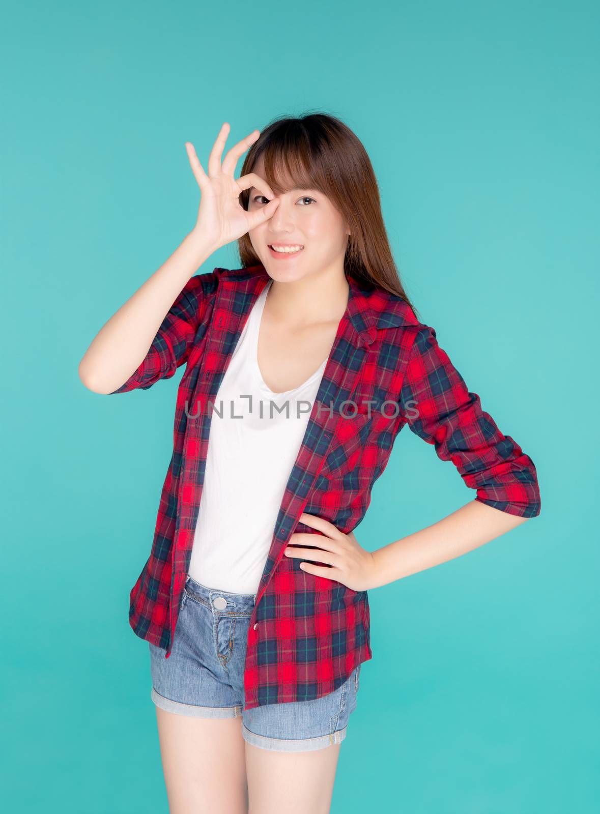 Beautiful happy young asian woman wear travel summer gesture ok  by nnudoo