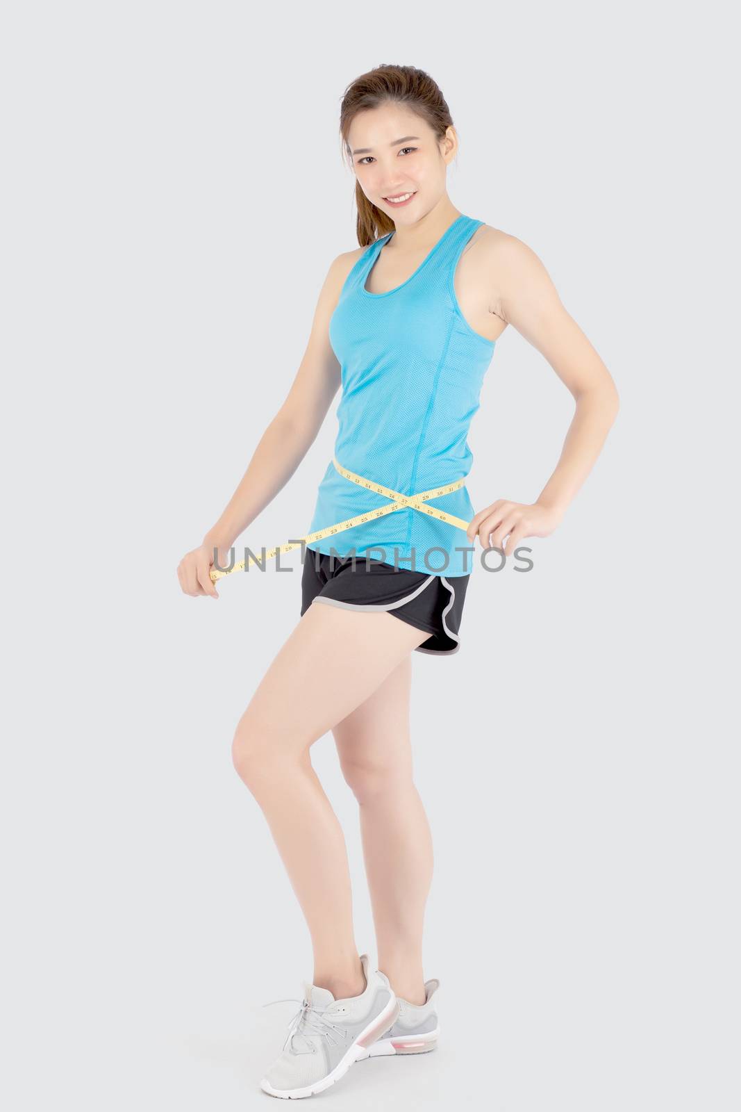 Beautiful slim young asian woman measuring tape thin waist wear  by nnudoo