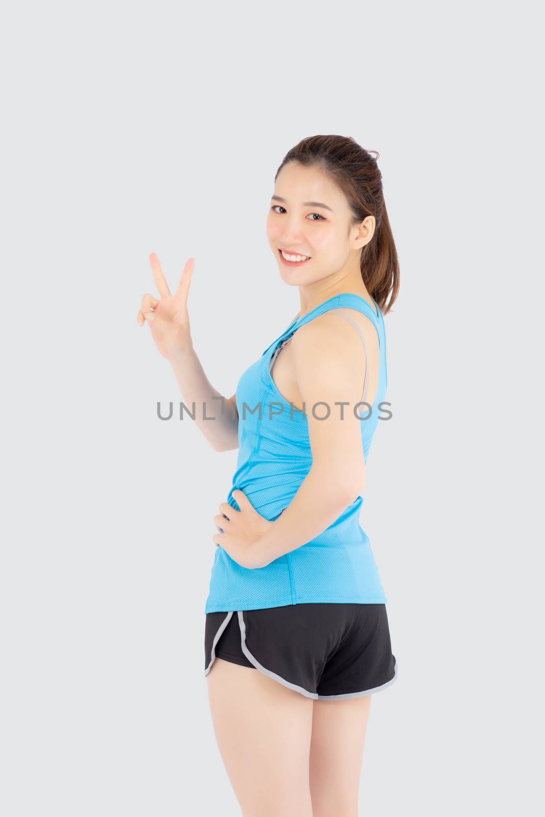 Beautiful portrait young asian woman in sport clothes with satisfied and confident gesture finger v sign isolated on white background, asia girl have shape and wellness, exercise for fit with health.