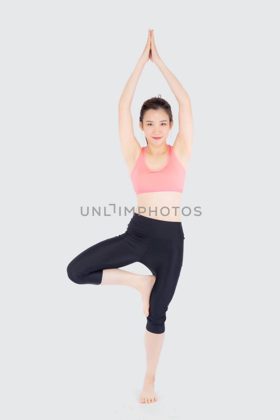 Beautiful happy young asian woman doing yoga exercise sport for  by nnudoo