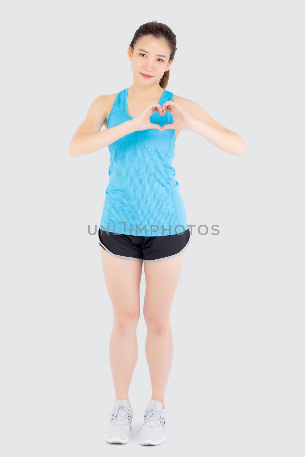 Beautiful young asian woman in sport with healthy gesture heart  by nnudoo