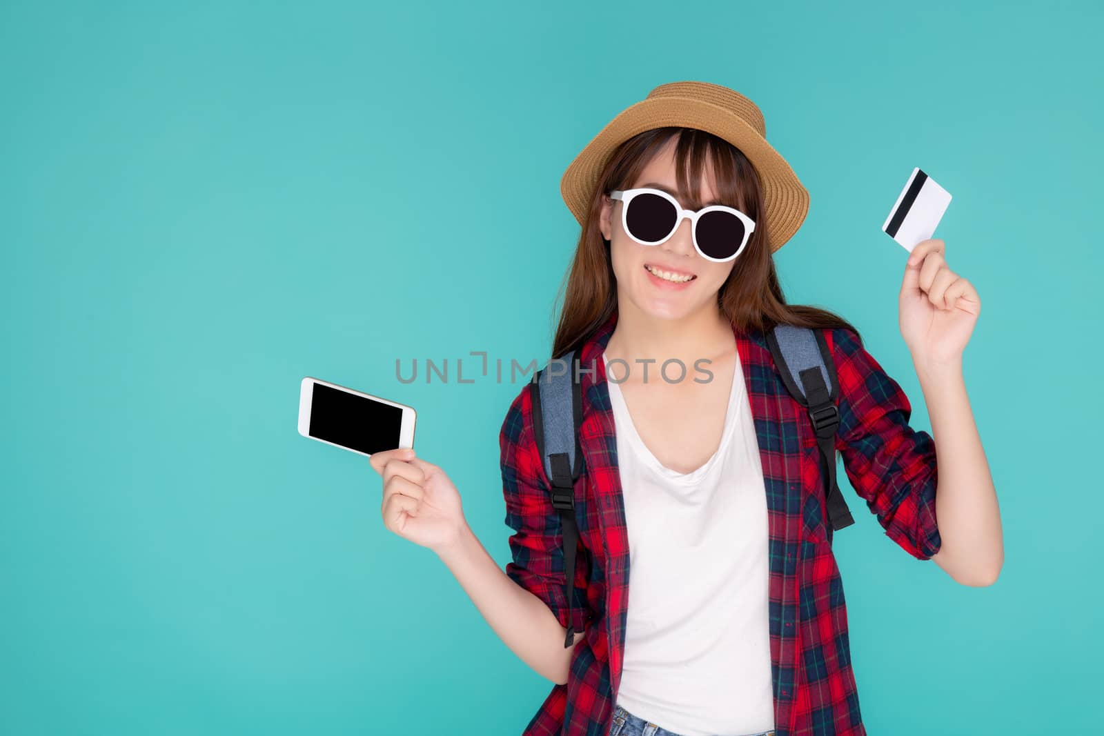 Beautiful portrait young asian woman wear travel summer fashion holding credit card and smart mobile phone in summer, asia girl payment for booking internet online with app in vacation.