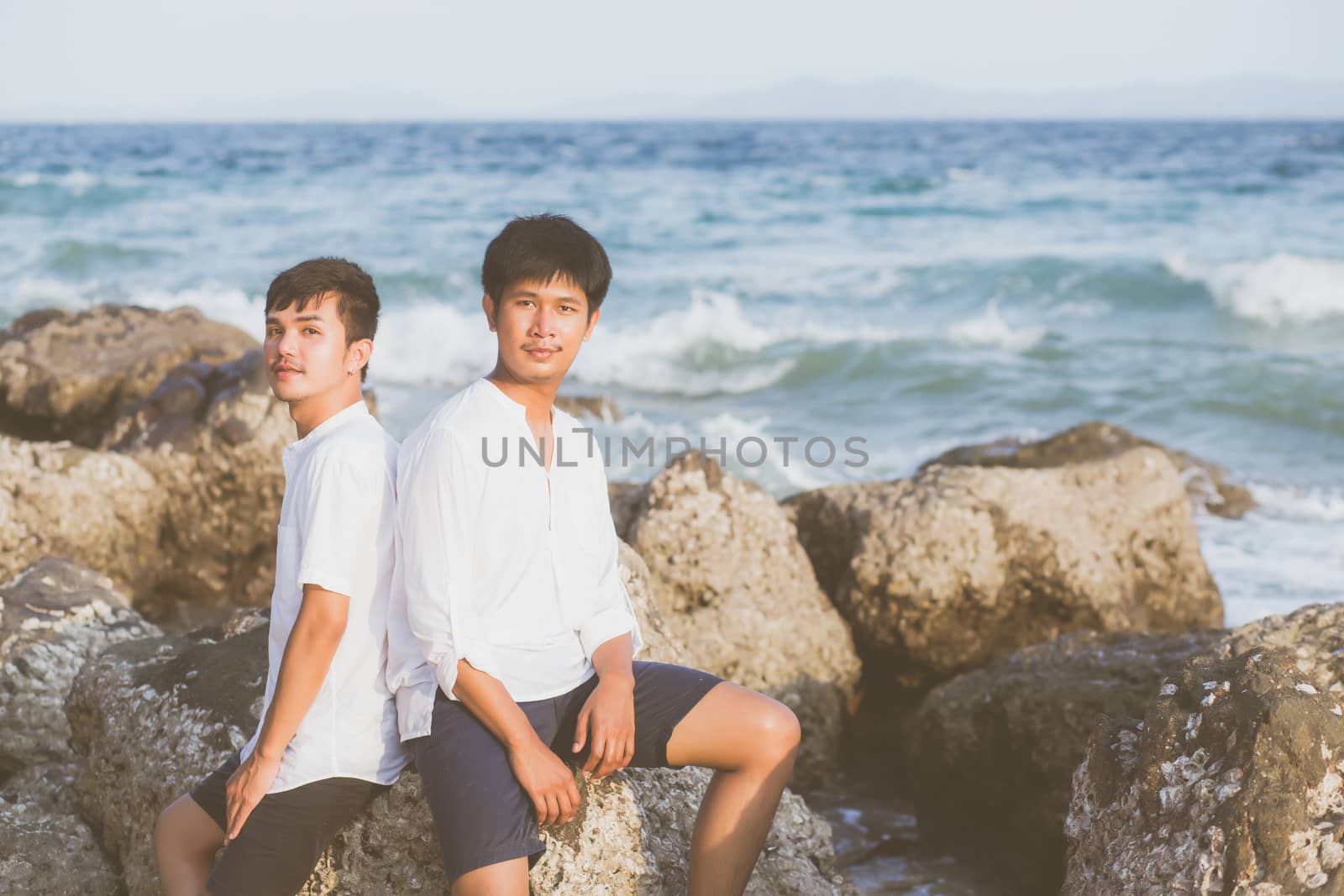Homosexual portrait young asian couple sitting hug together on r by nnudoo
