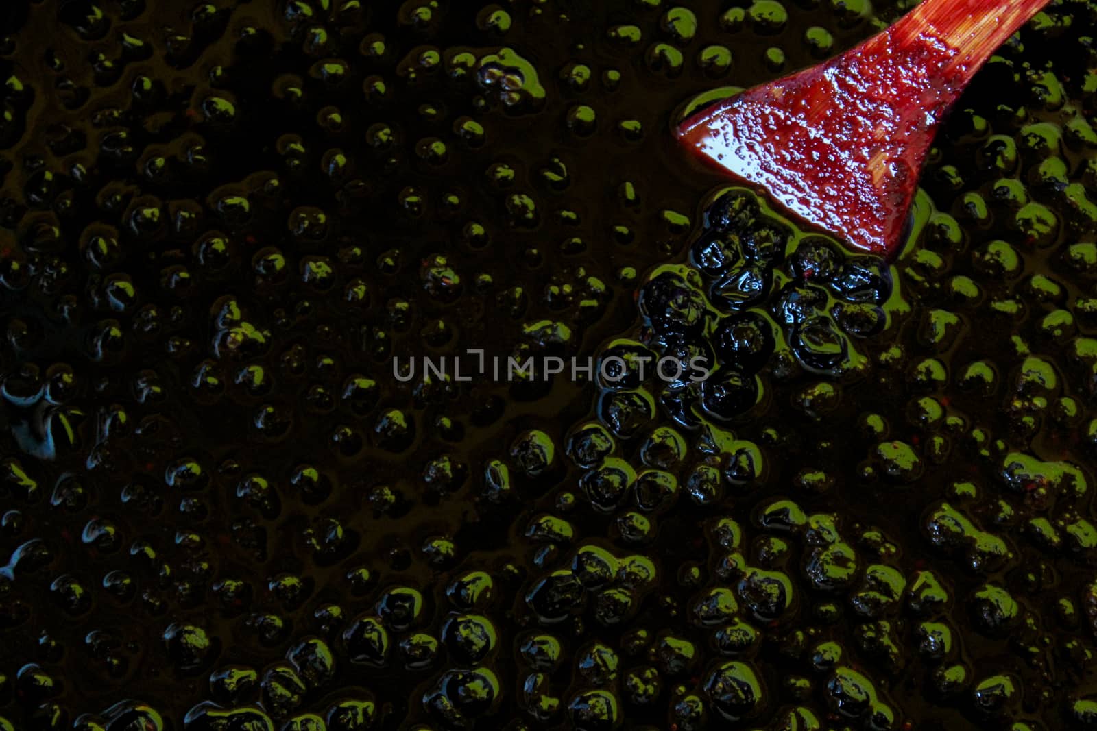 Chokeberry berries on the surface in chokeberry jam. by mahirrov
