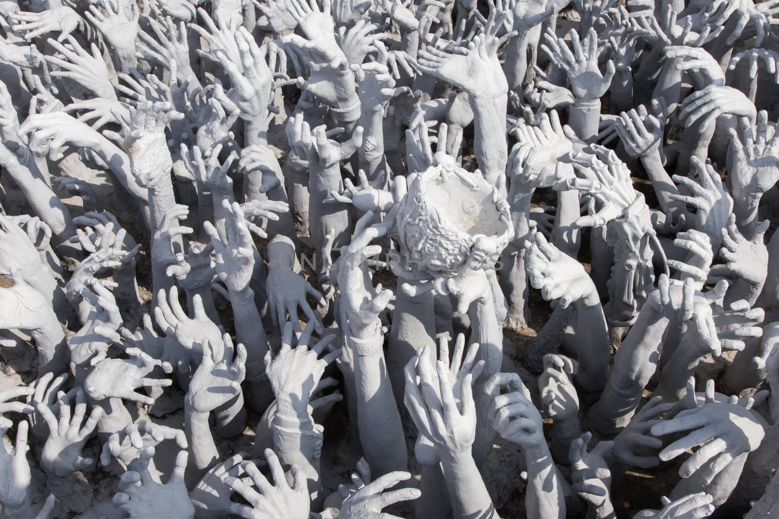 Wat Rong Khun Chiang Mai Thailand 12.10.2015 White Temple and tourists with hands from hell. High quality photo