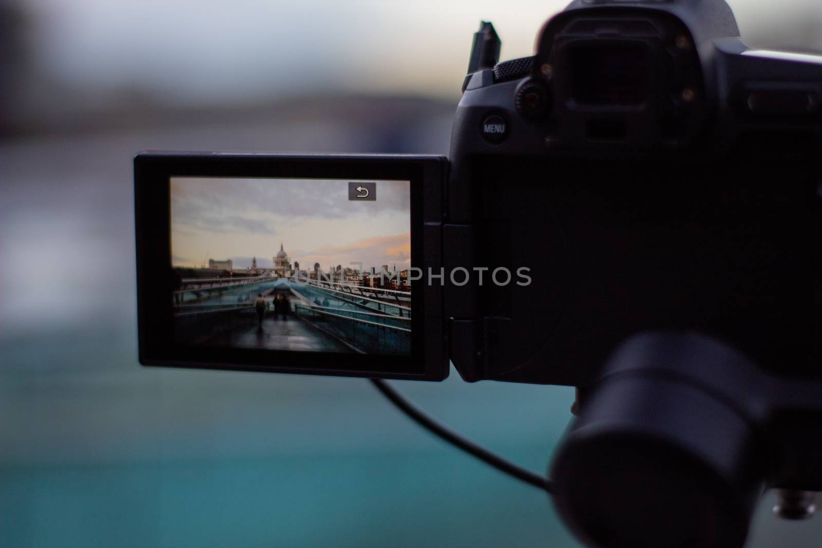 Millennium Bridge ramp and Saint Paul Cathedral on screen of digital camera recording. Camera capturing a cityscape from London. Photography and video equipment