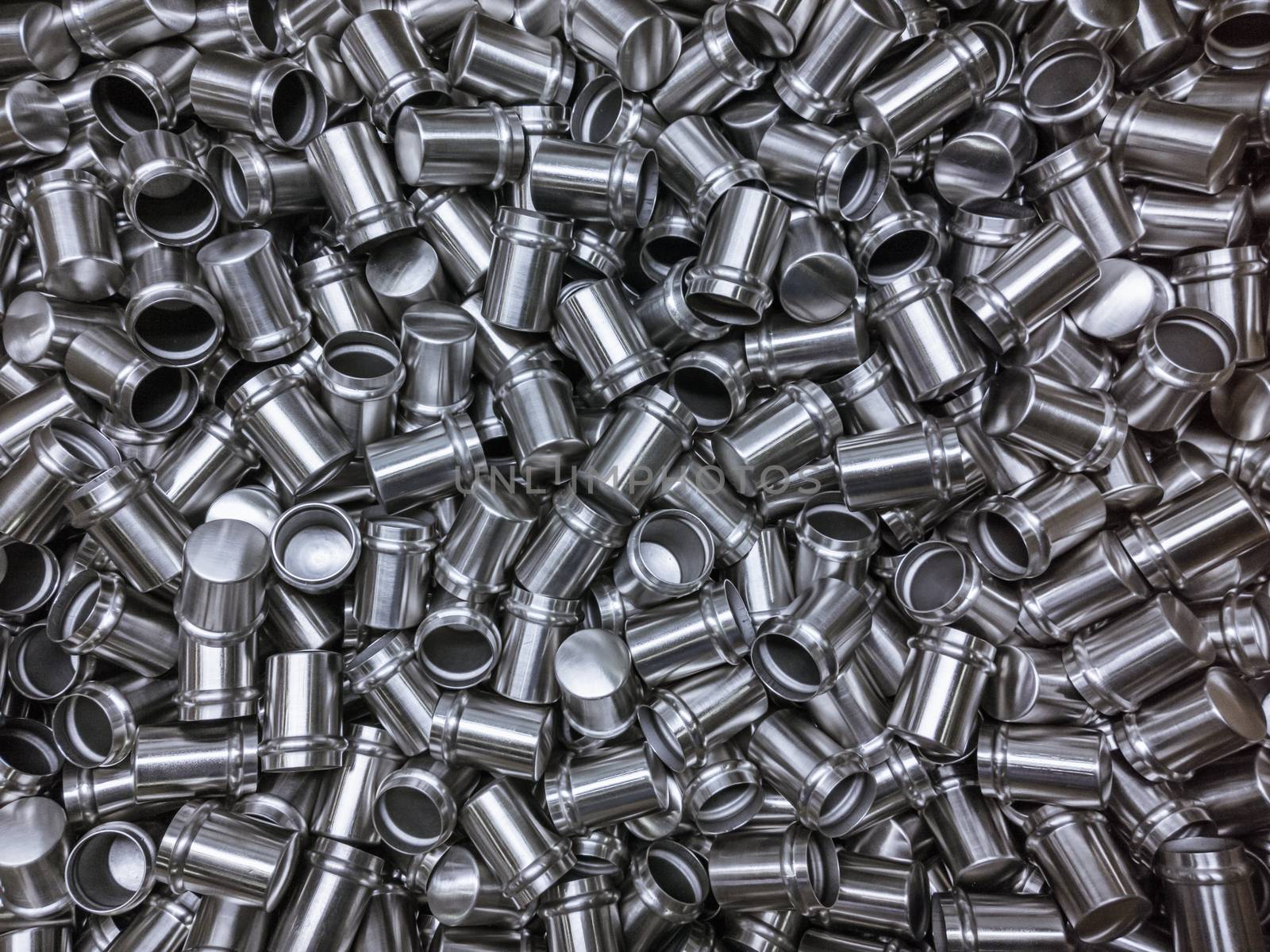 Shiny cold deformated cylindrical steel body parts flat background