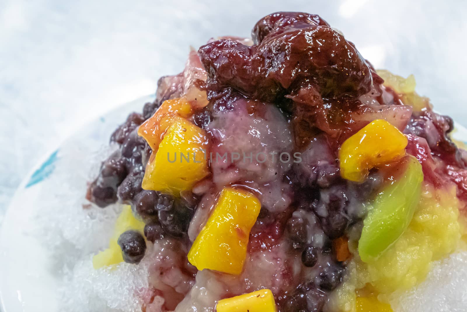 Taiwanese mixed fruit shaved Ice snowflake smoothie at night market in Kaohsiung, Taiwan. by phasuthorn