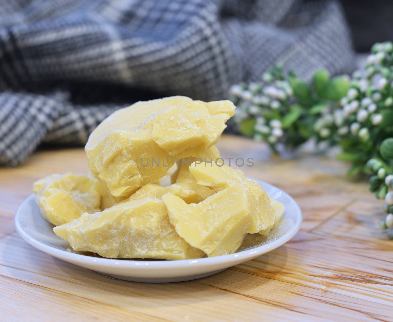 Natural cocoa butter oil in a wooden bowl on a brown background by lucia_fox