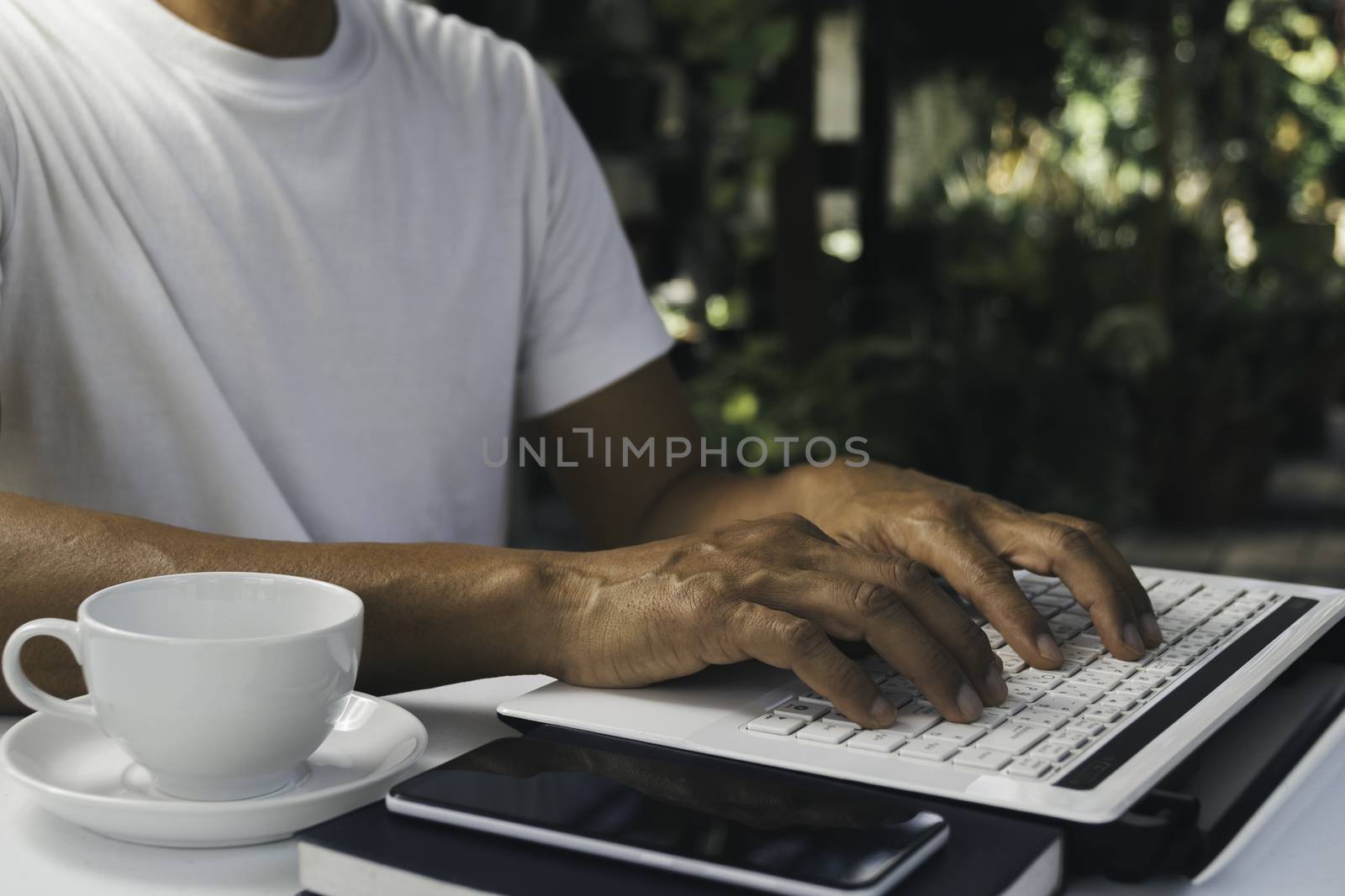 A man working at home and using laptop on the table. Technology  by kirisa99