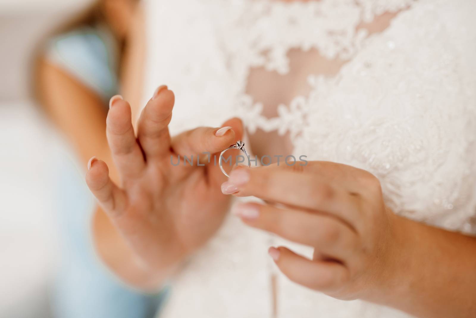 the bride gently touches her dear engagement ring by Andreua