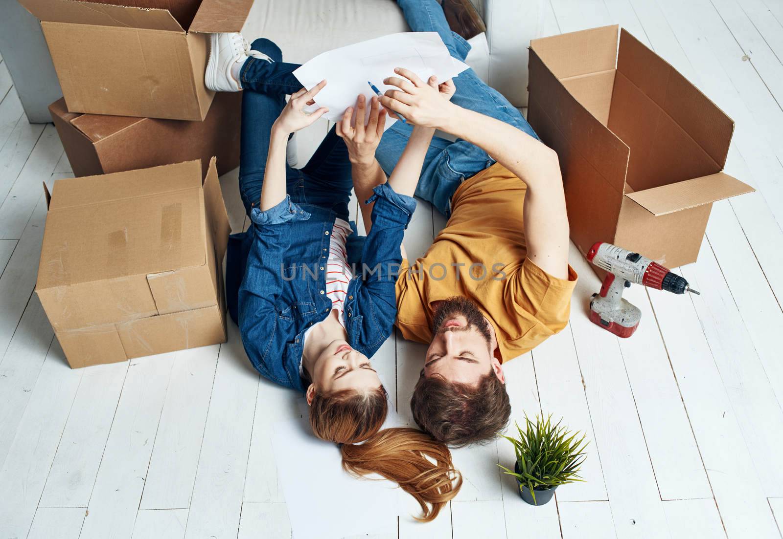 Watching TV married couple man and woman on the couch and a flower in a pot. High quality photo