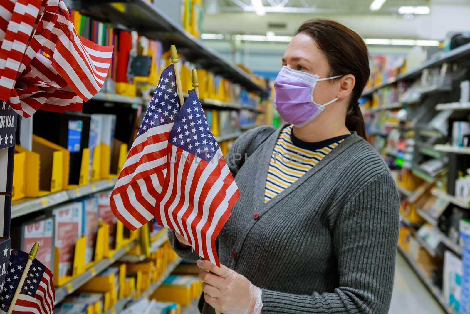 A young woman shopping in a supermarket during a virus epidemic on face under the mask with coronavirus COVID-19