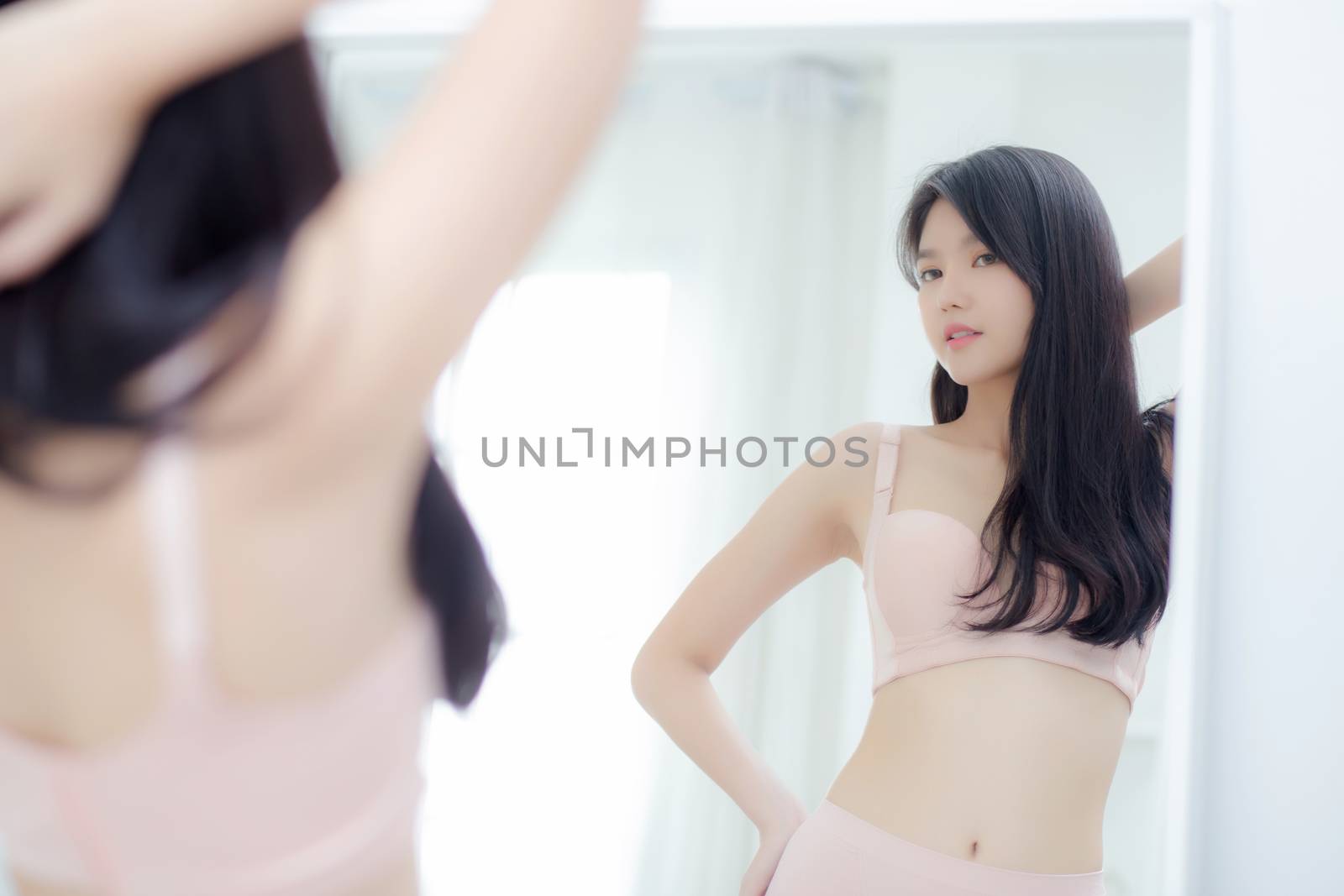 Lifestyle of beautiful young asian woman in underwear looking in by nnudoo