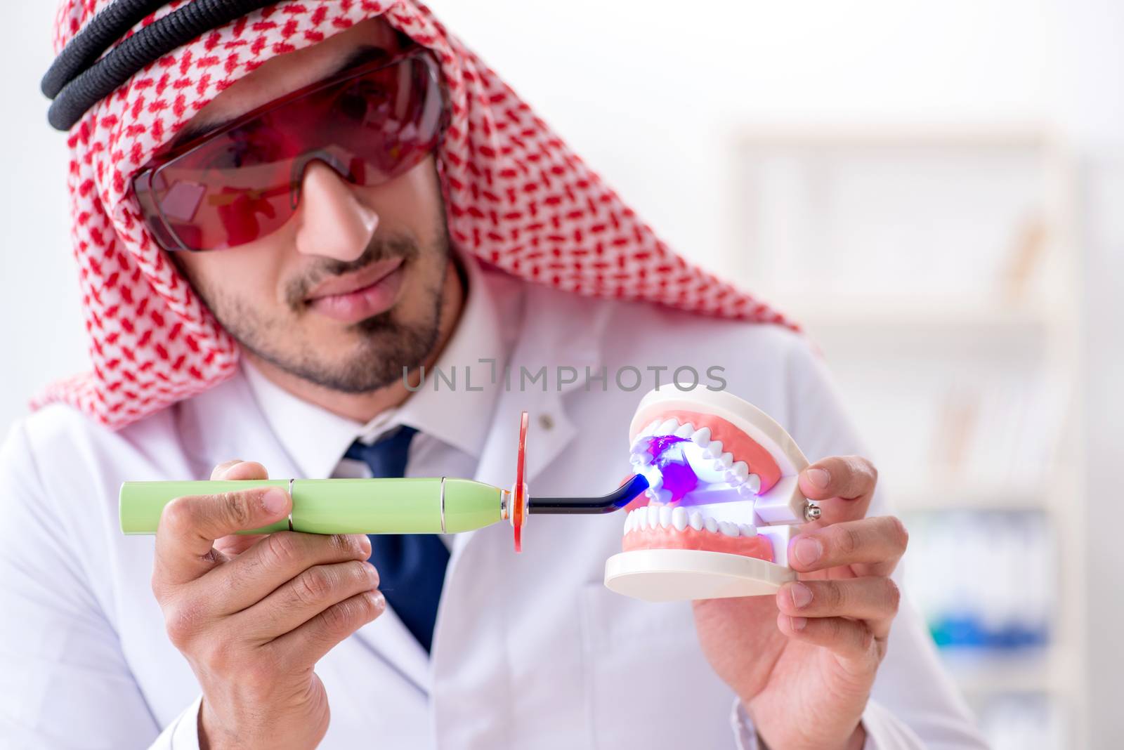 Arab dentist working on new teeth implant