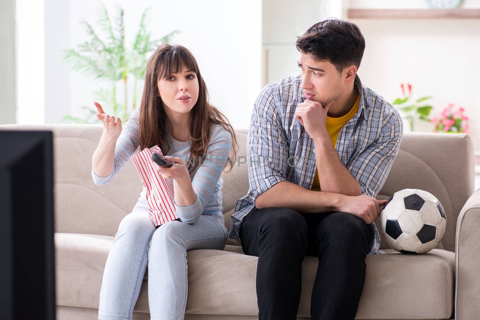 Family pair watching football at home