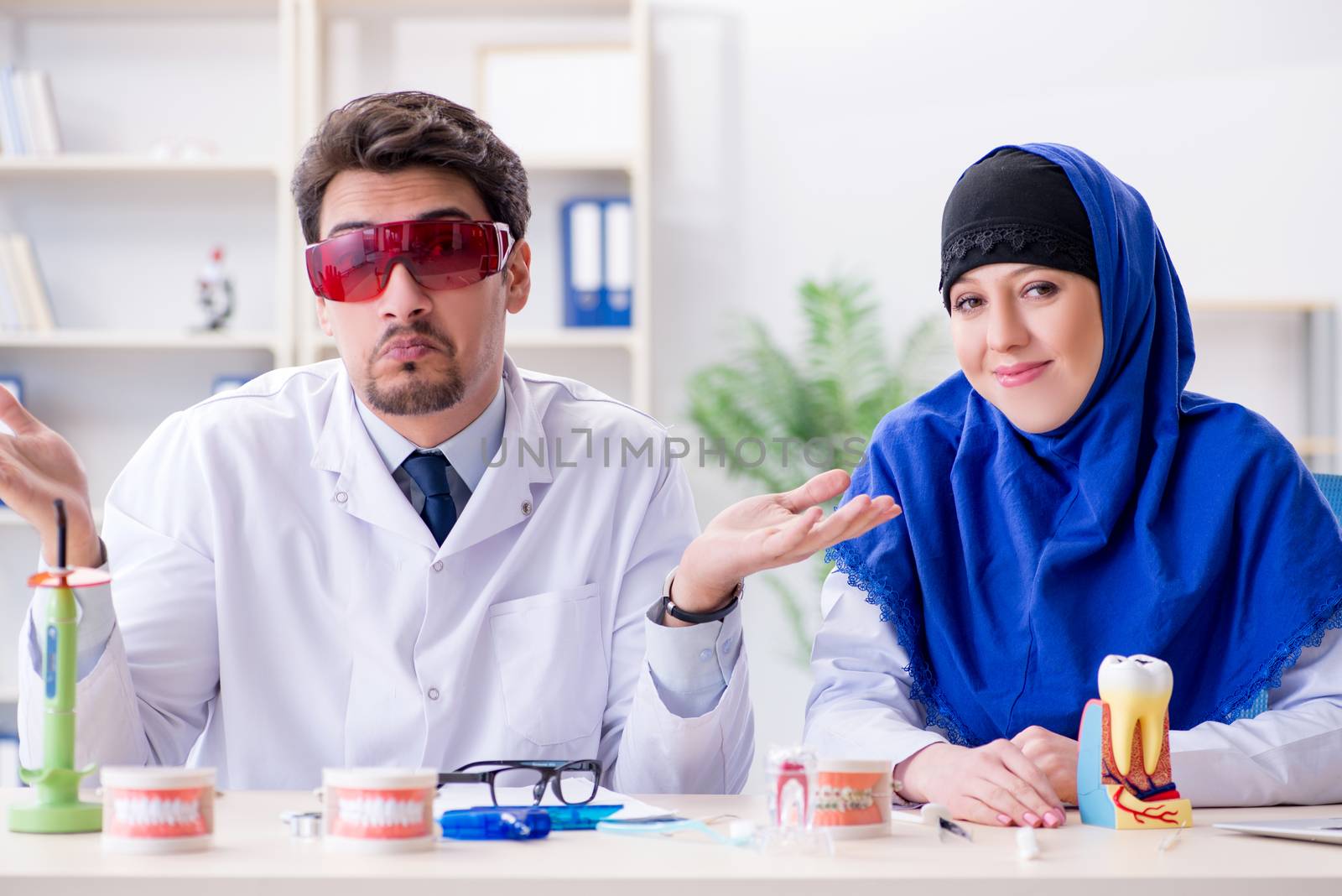 Dentist doctor and assistant working on new tooth implant