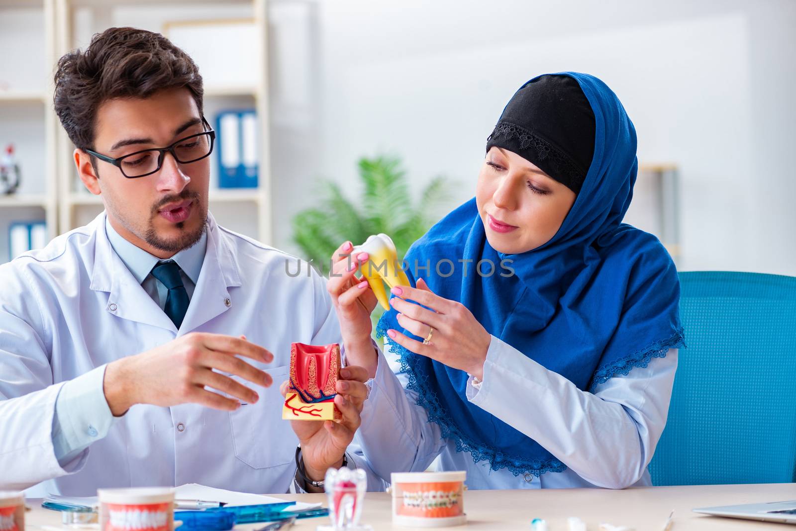 Dentist doctor and assistant working on new tooth implant