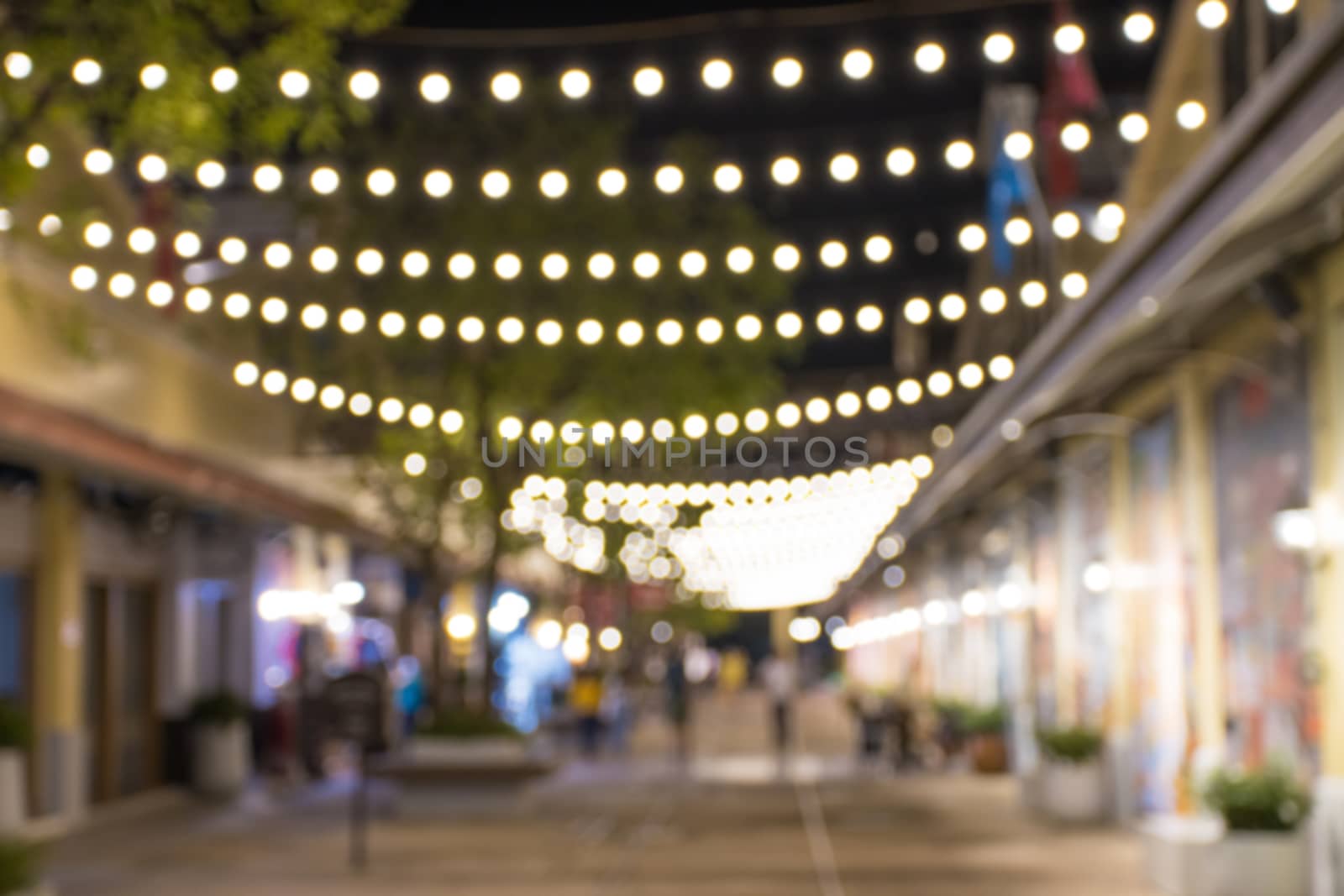 abstract blur image of night festival in a restaurant and market by piyaphun