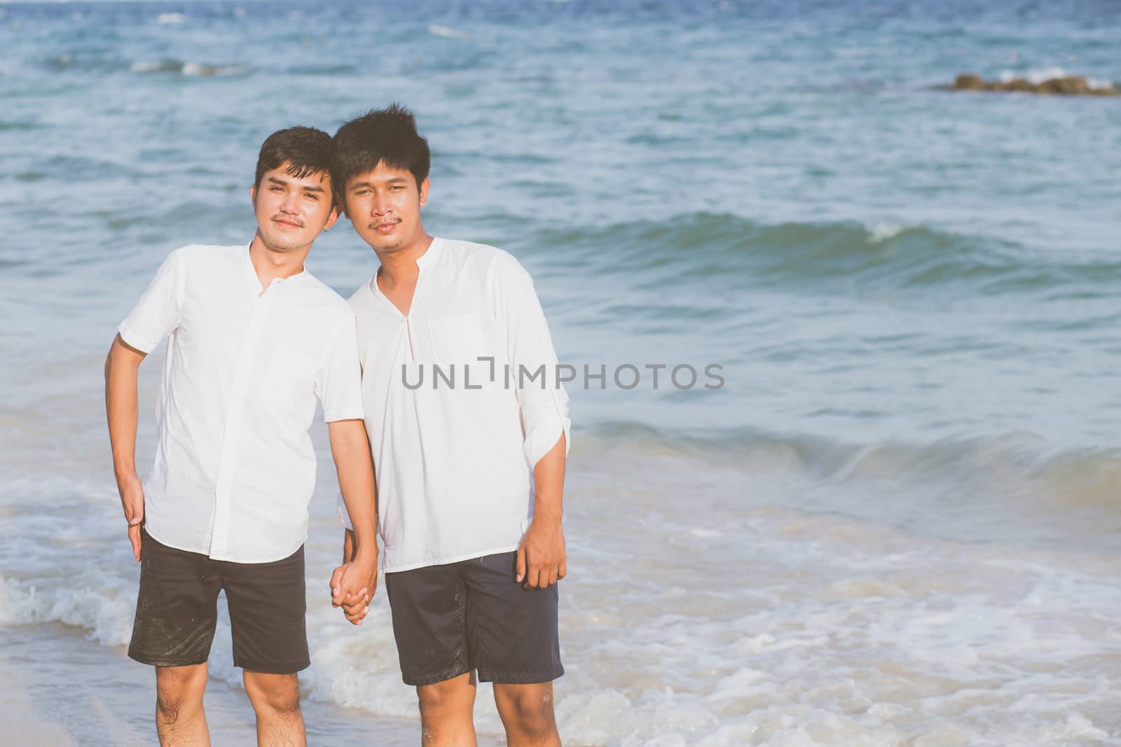 Homosexual portrait young asian couple standing together on beac by nnudoo