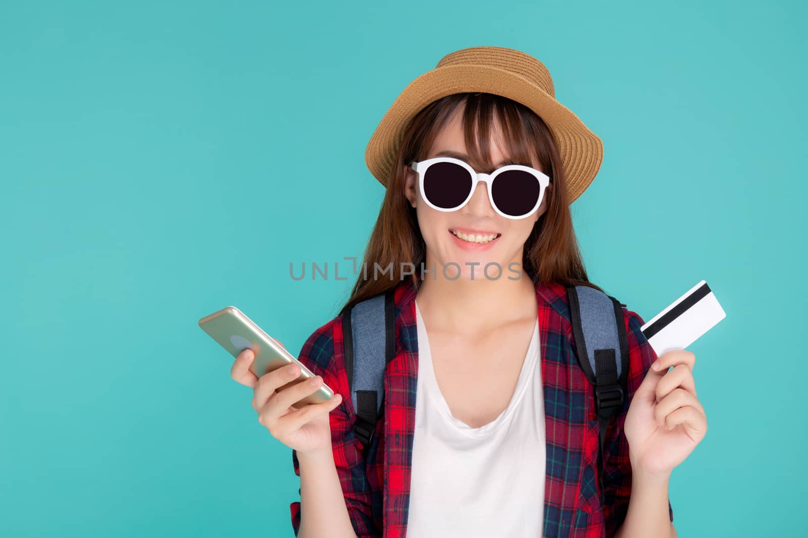 Beautiful portrait young asian woman wear travel summer fashion holding credit card and smart mobile phone in summer, asia girl payment for booking internet online with app in vacation.