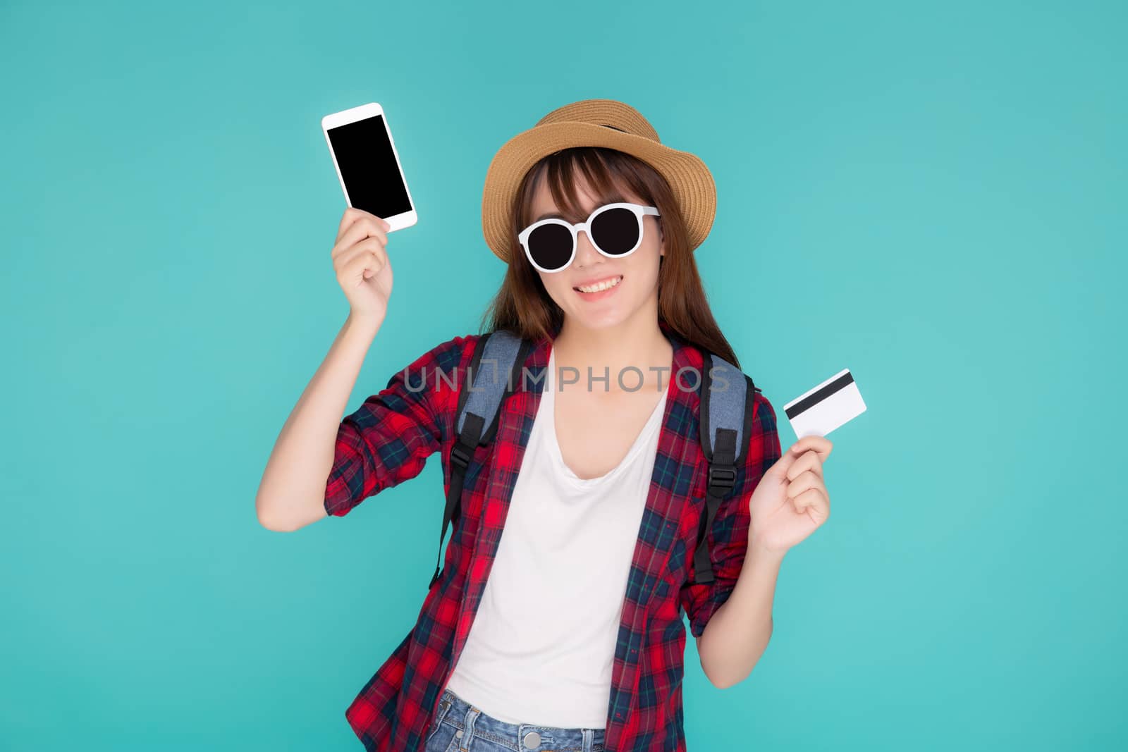 Beautiful portrait young asian woman wear travel summer fashion holding credit card and smart mobile phone in summer, asia girl payment for booking internet online with app in vacation.