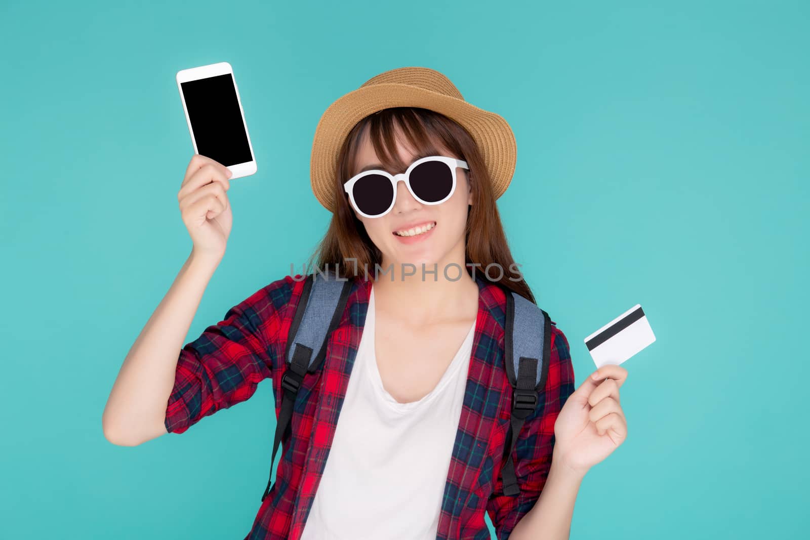 Beautiful portrait young asian woman wear travel summer fashion holding credit card and smart mobile phone in summer, asia girl payment for booking internet online with app in vacation.
