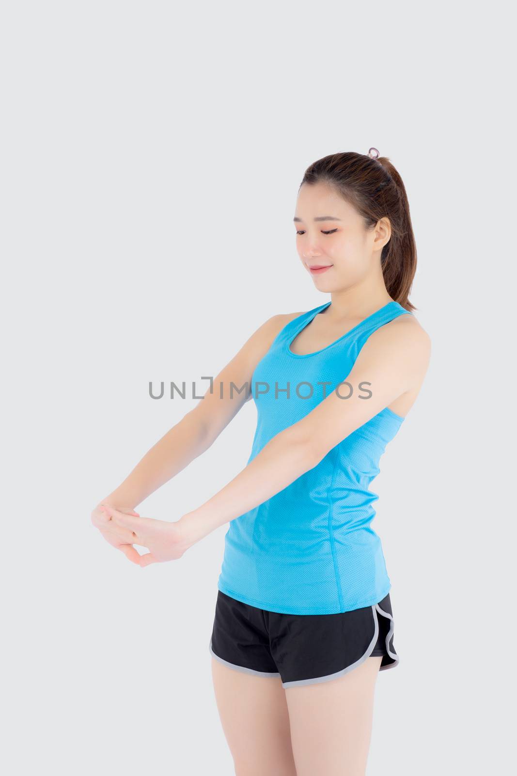 Beautiful young asian woman in sport standing stretch muscle arm by nnudoo