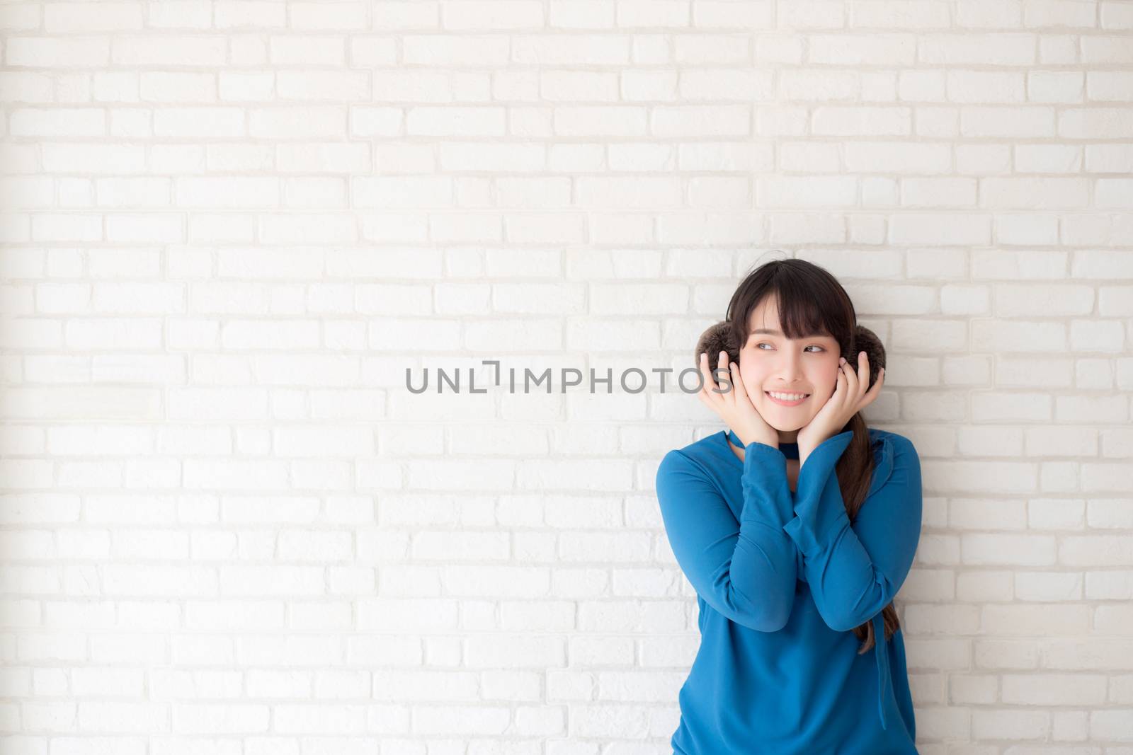 Portrait of beautiful young asian woman enjoy and happiness standing on gray cement texture grunge wall brick background, girl is a smiling and cheerful on concrete.