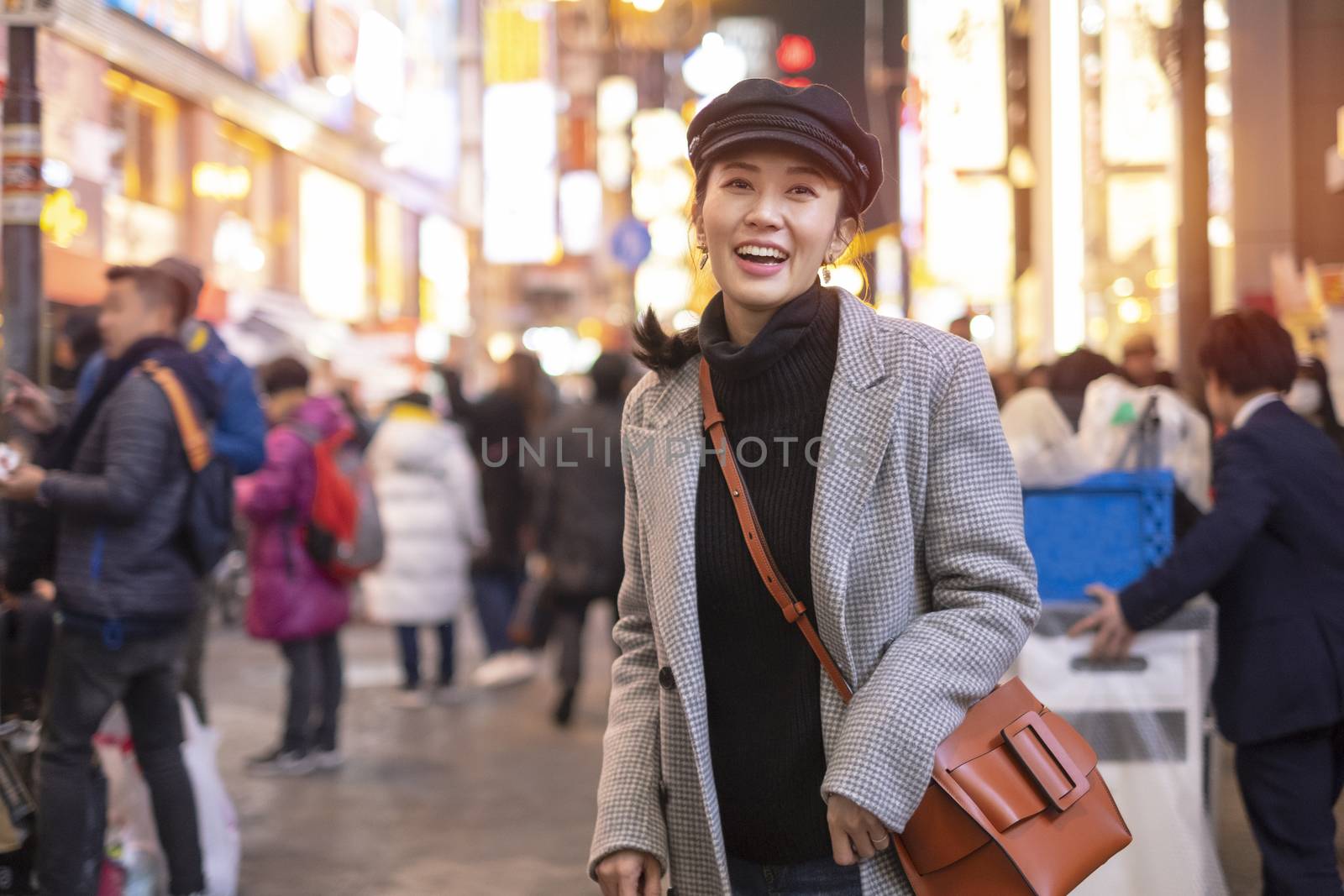 Beautiful smiling woman tourists traveling in walking at street  by Surasak