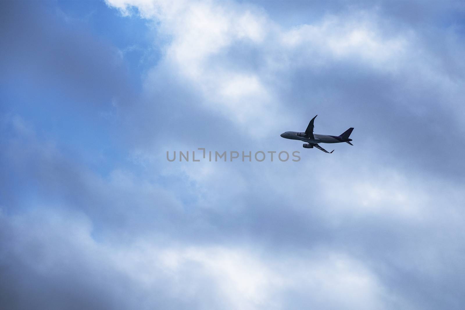 Airplane flying in the strom  by Surasak