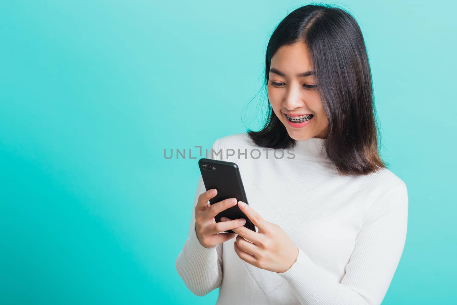 woman smile she holding and typing text message by Sorapop
