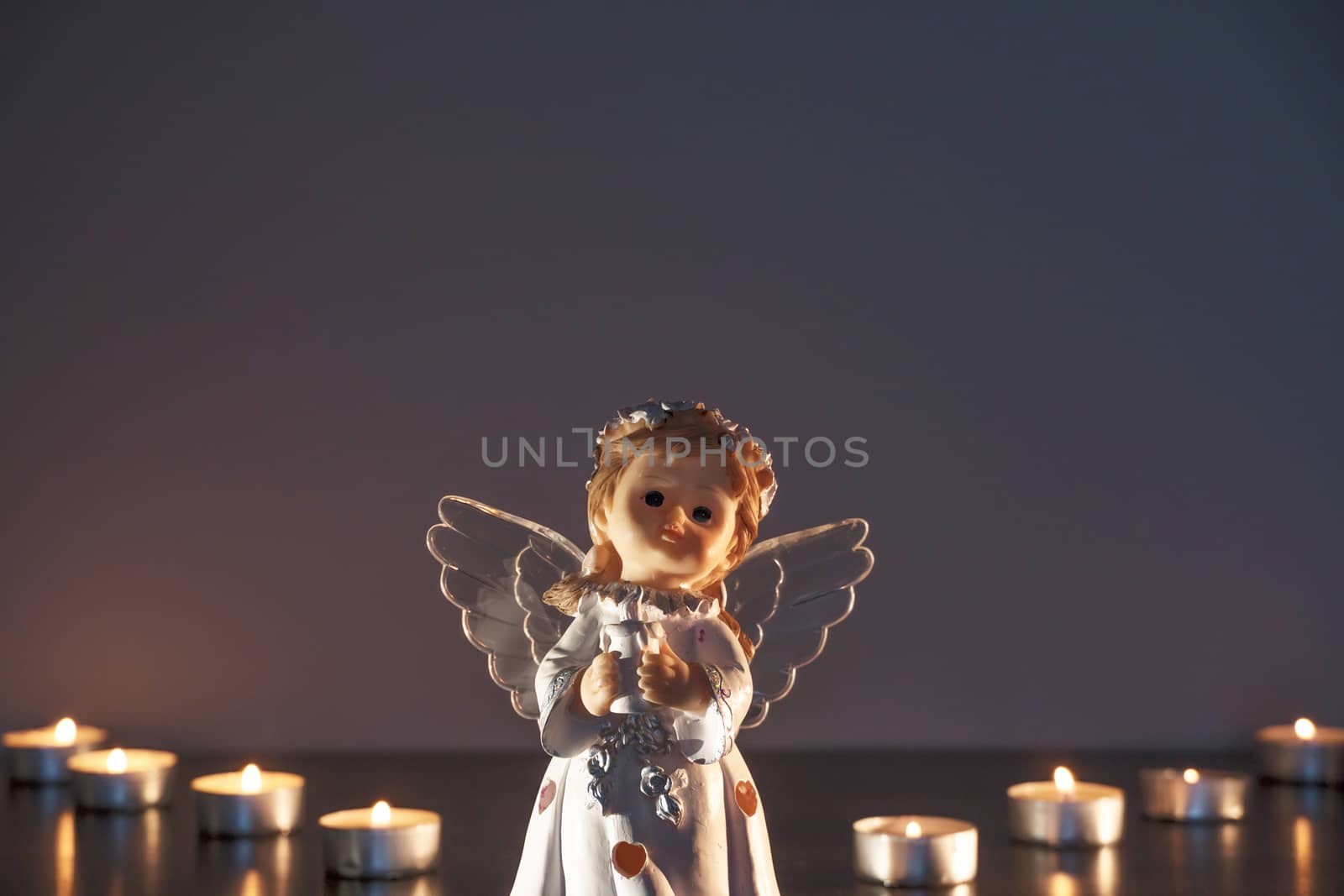 White Christmas angel with lighted candles in the Church. Spirit by YevgeniySam