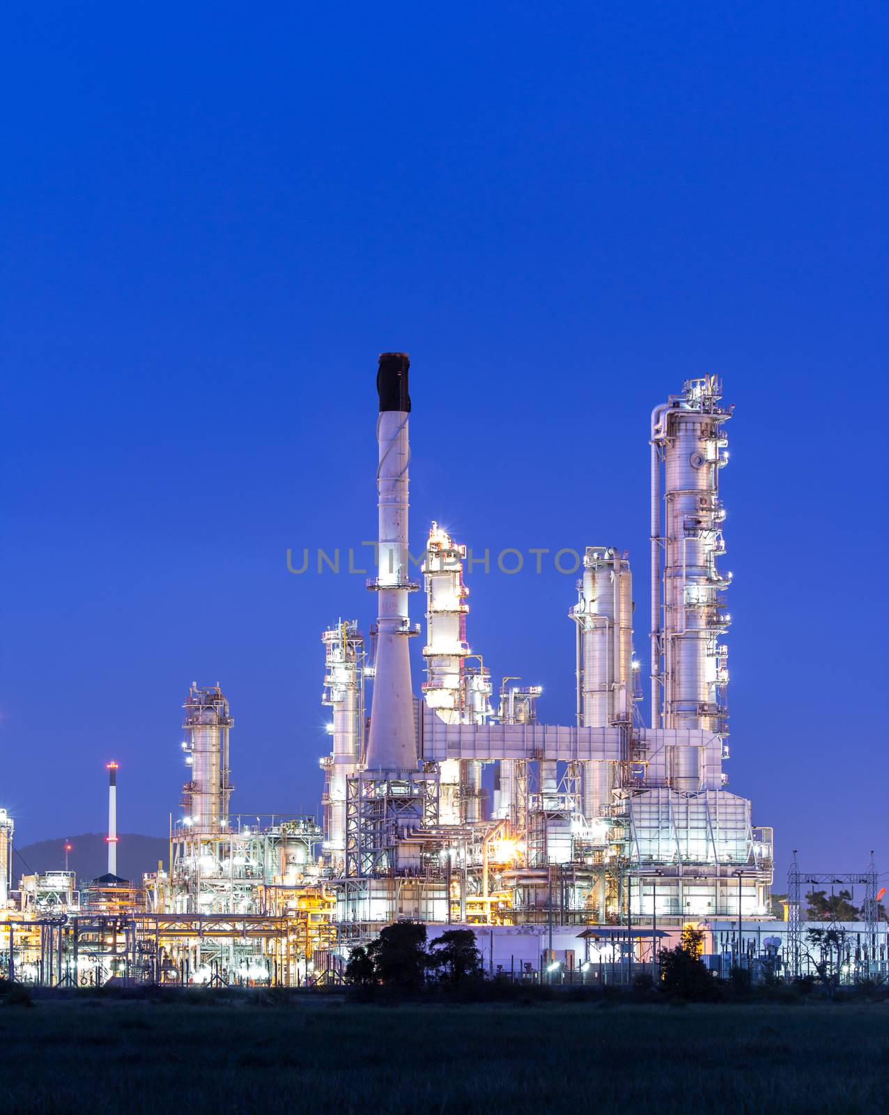 Oil refinery plant at twilight dark blue sk