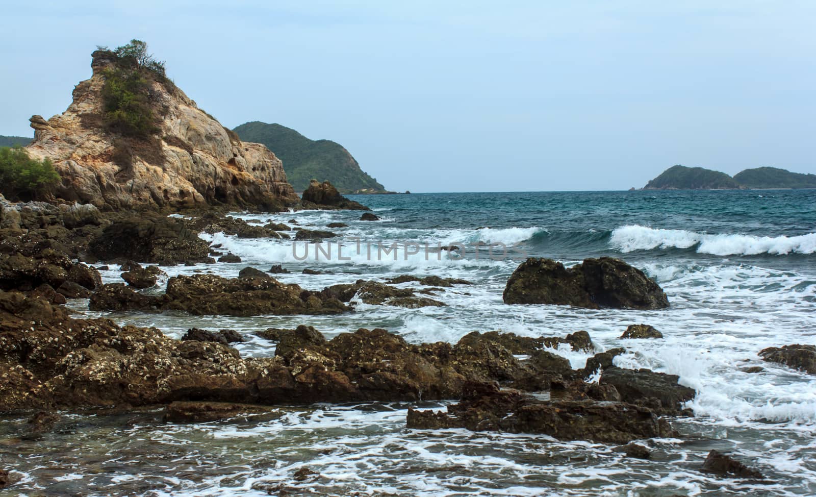 Rocky coast with sea waves  by Praphan