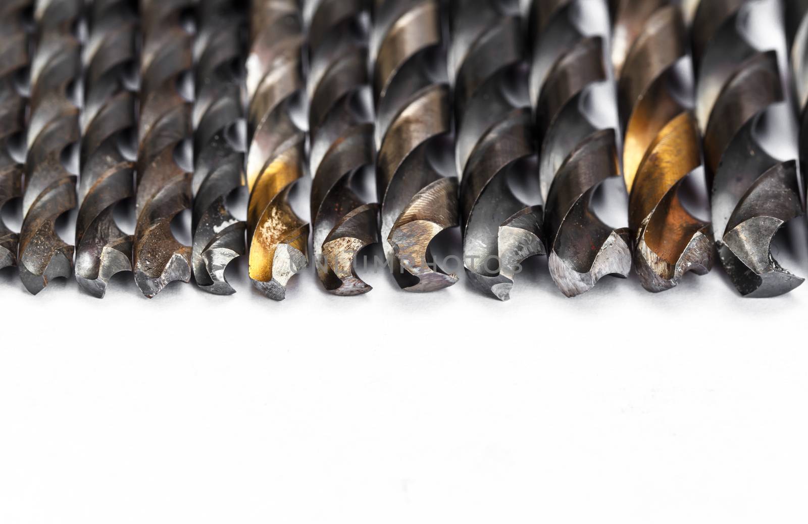 Various used twist drill bits in a row