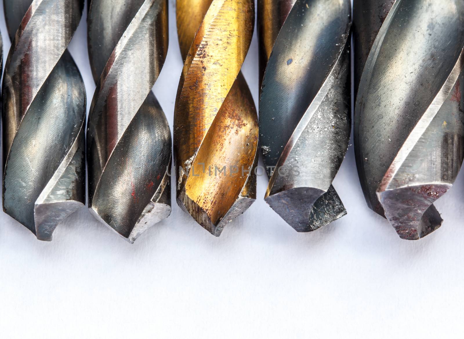 Various used twist drill bits in a row