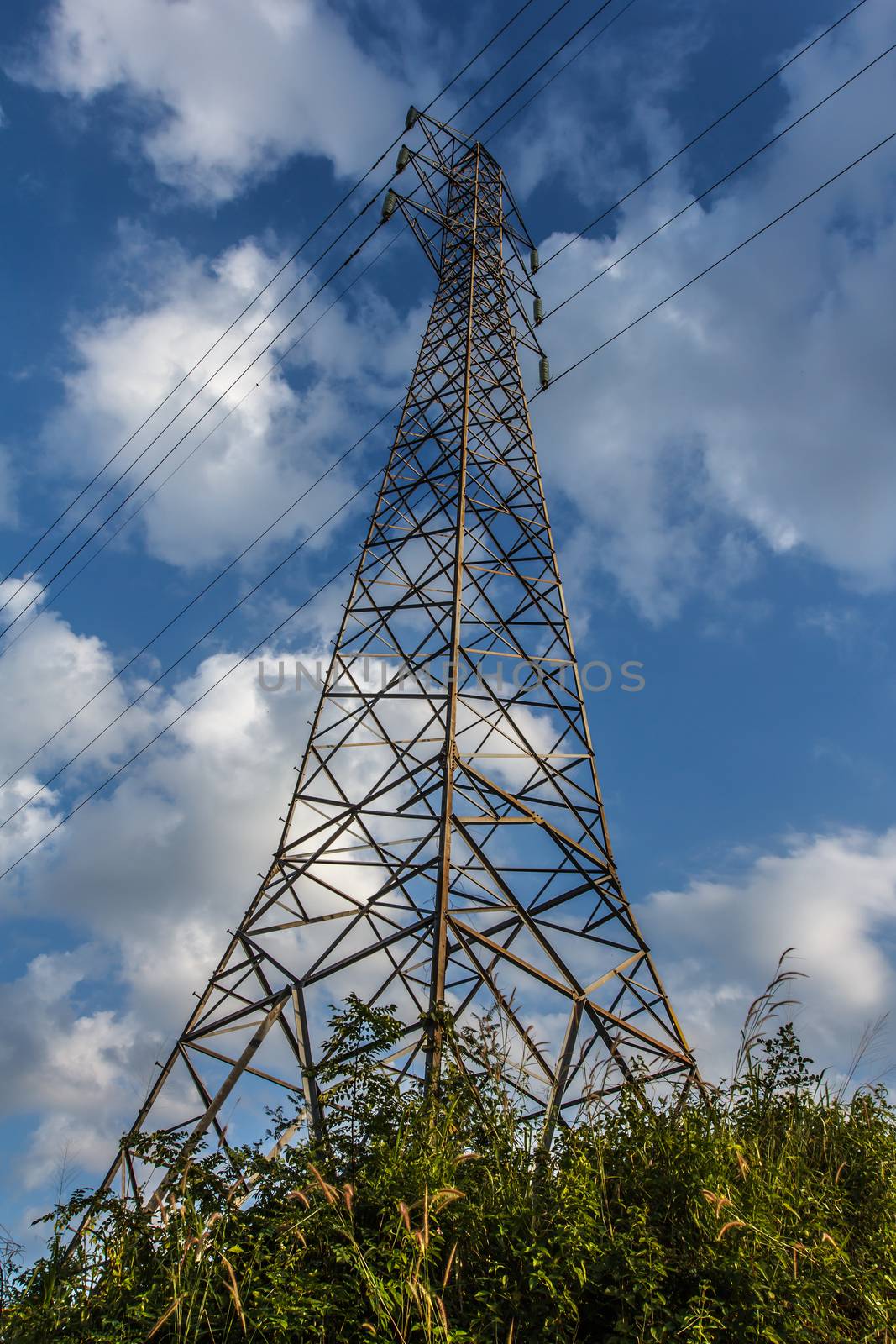 Power transmission lines against blue sky