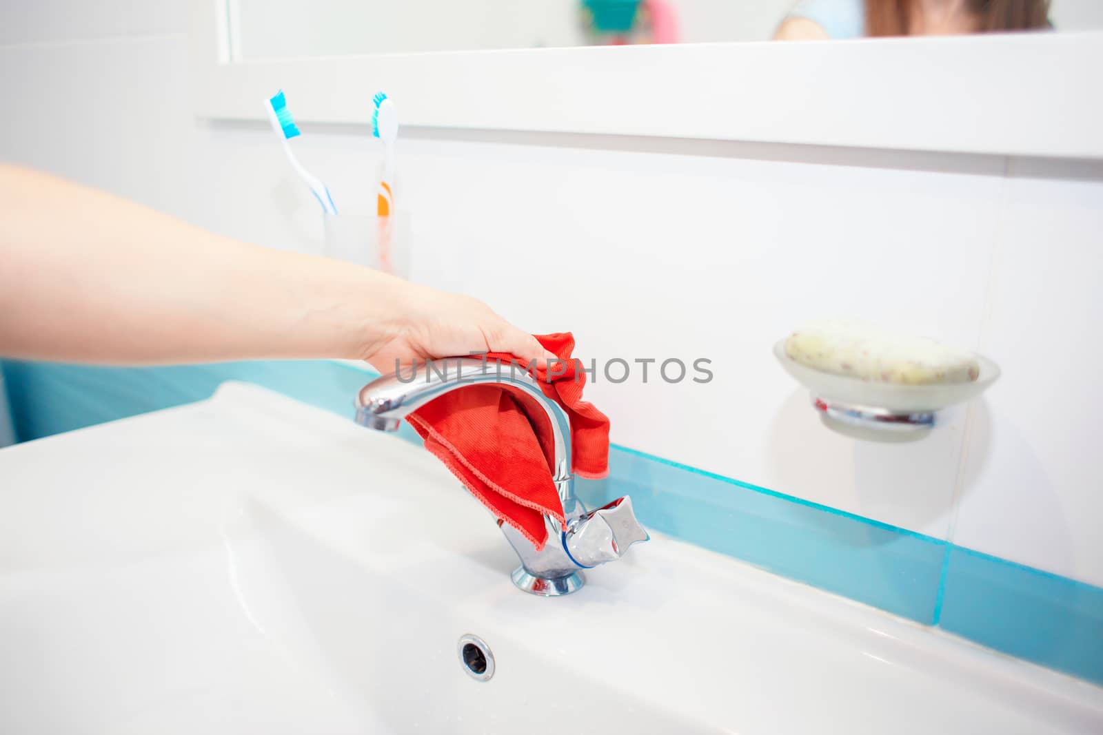 Washing the sink and faucet in the bathroom. Disinfection at home. Tidying up the house. Spring-cleaning. Toilet cleaning. Cleaning the sink with a rag