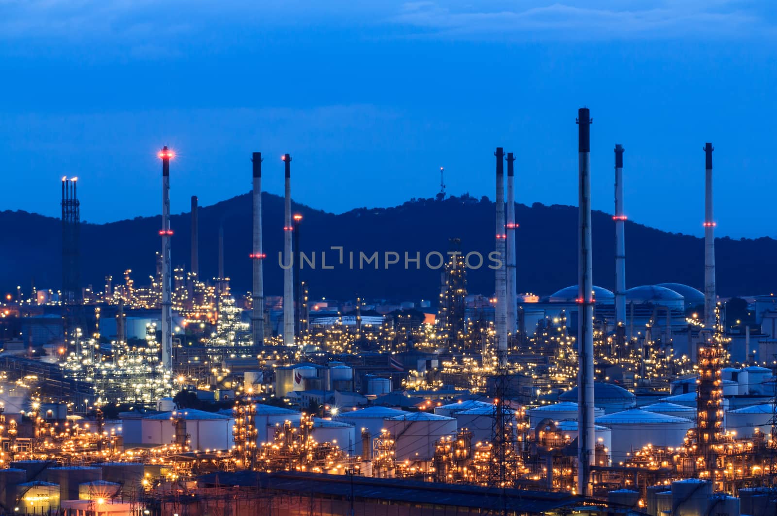 Light oil refinery at night. by Praphan