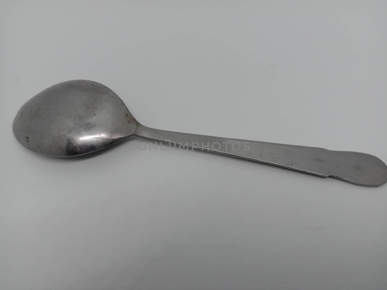 steel spoon closeup on white background