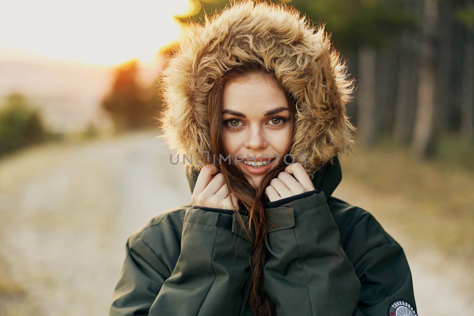 Woman warm jacket with a hood outdoors fresh air Freedom lifestyle. High quality photo